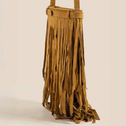 Brown suede fringe bag on a beige background