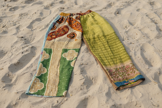 Cotton patch pants on sand background 