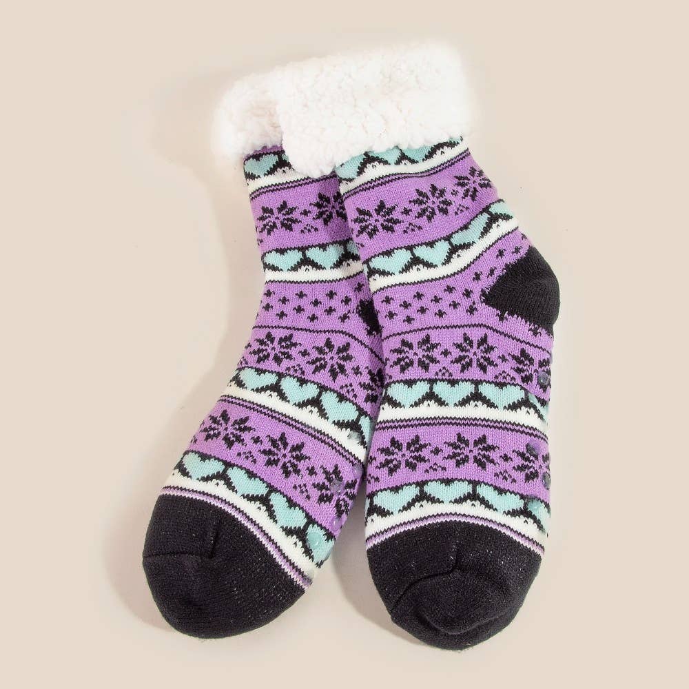 Pair of purple and black patterned socks with white fur lining on a beige background