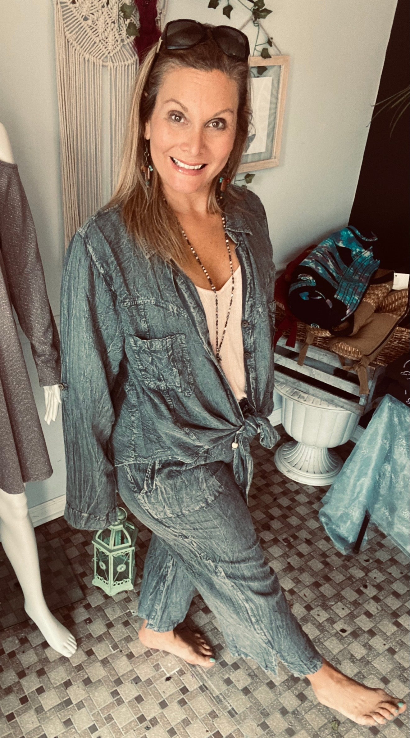 Woman standing on tile floor wearing 2-piece matching over dyed denim outfit