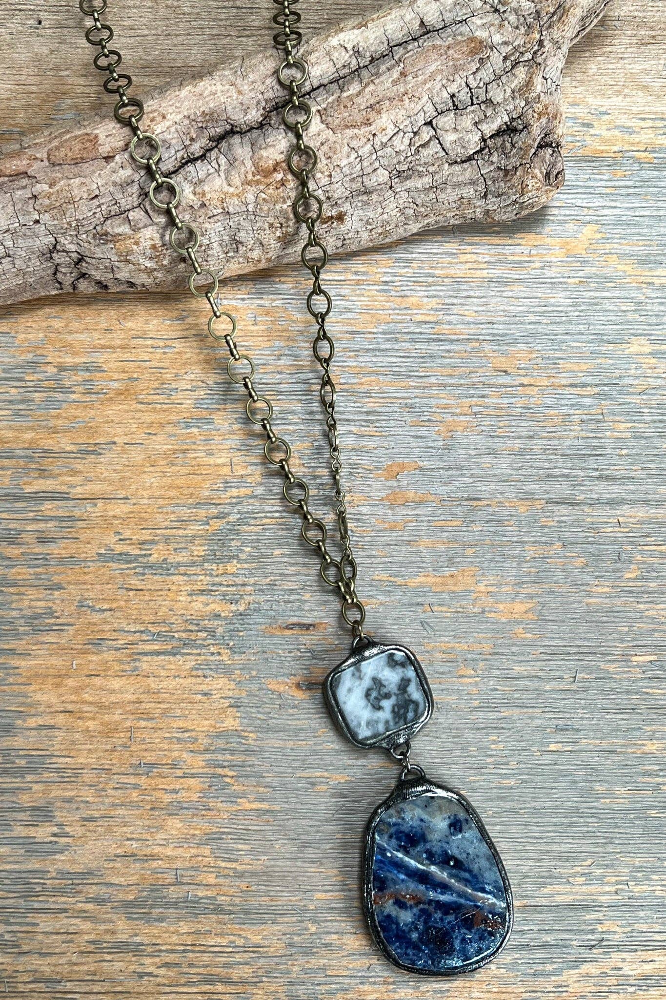 Necklace with blue stone pendants on a wooden surface