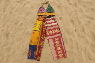 Patchwork cotton pants paired with patch bikini on sand