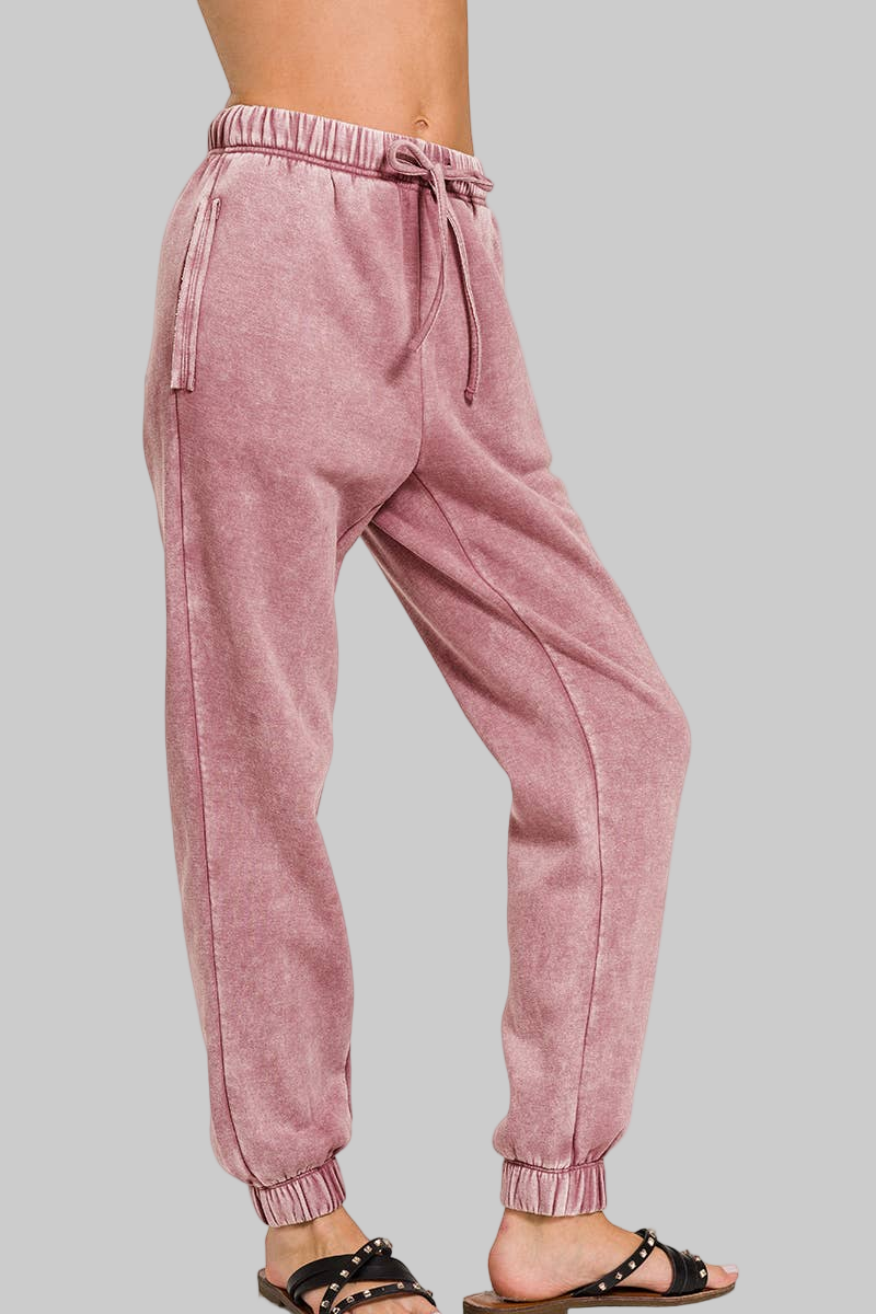 Light rose acid wash jogger pants on a white background