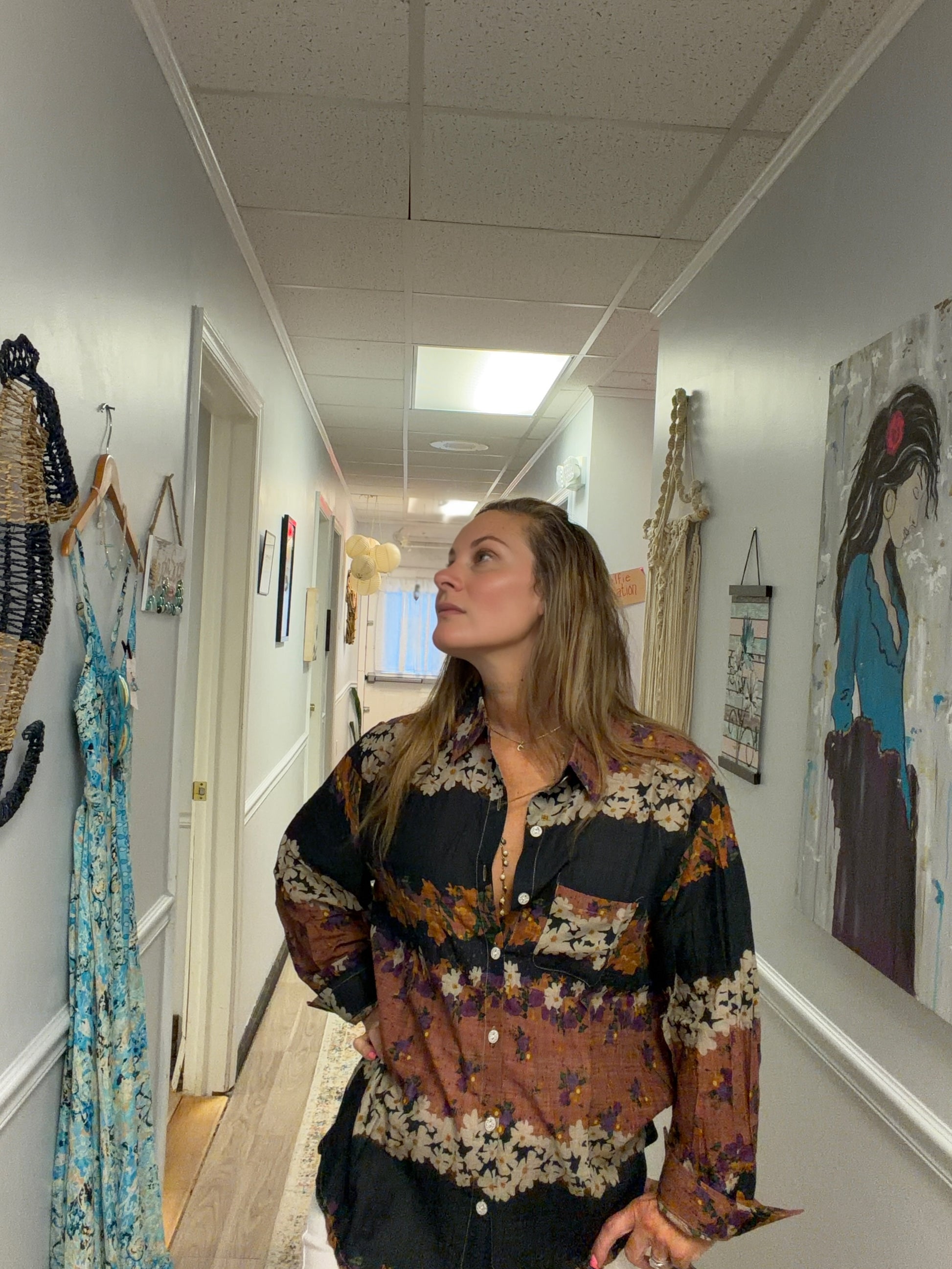Woman wearing a brown floral striped button down shirt in a spa 