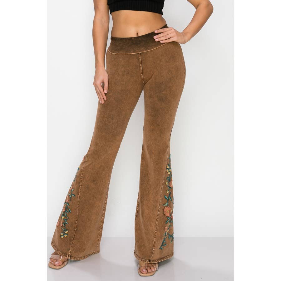 Brown flared pants with floral embroidery on a white background