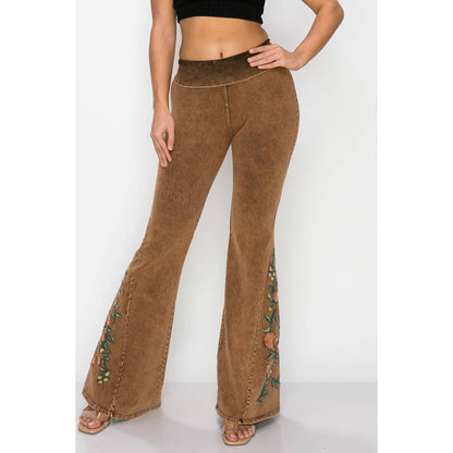 Brown flared pants with floral embroidery on a white background
