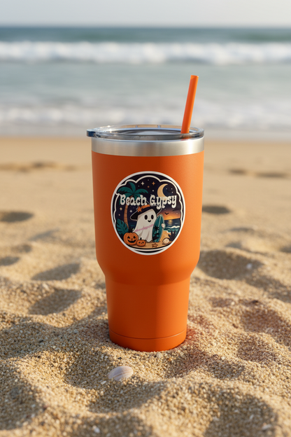 3” round Beach Gypsy Halloween sticker on an orange tumbler cup with a beach in the background 