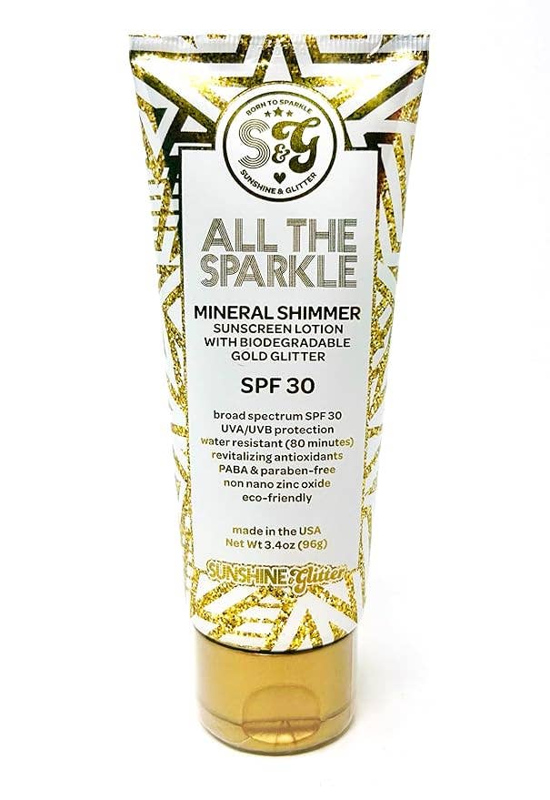 Sunscreen lotion tube with gold and white design on a white background