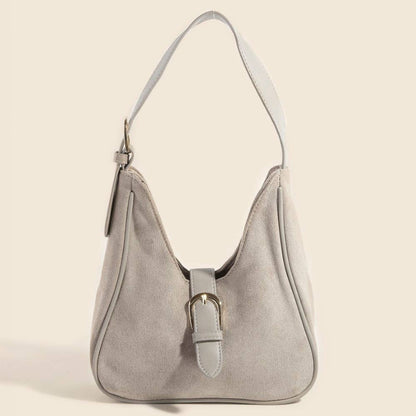Gray handbag with a buckle on a beige background