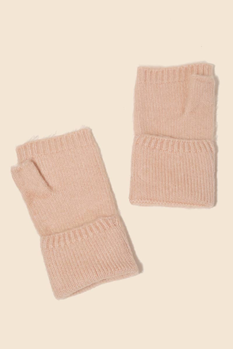 Pair of pink knitted fingerless gloves on a beige background