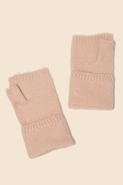 Pair of pink knitted fingerless gloves on a beige background