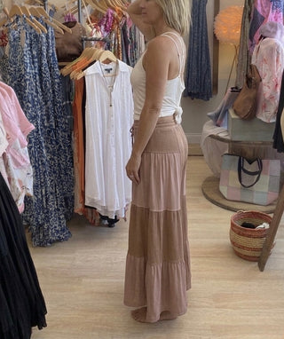 Side view of chocolate colored flowy pants on a model