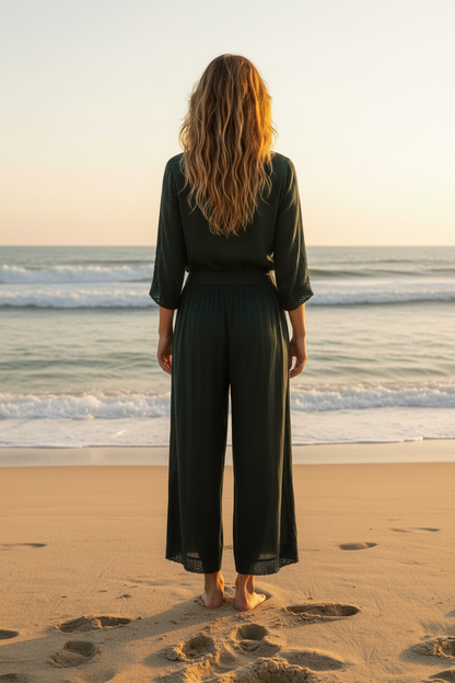 Woman with back facing with black gauze pants on