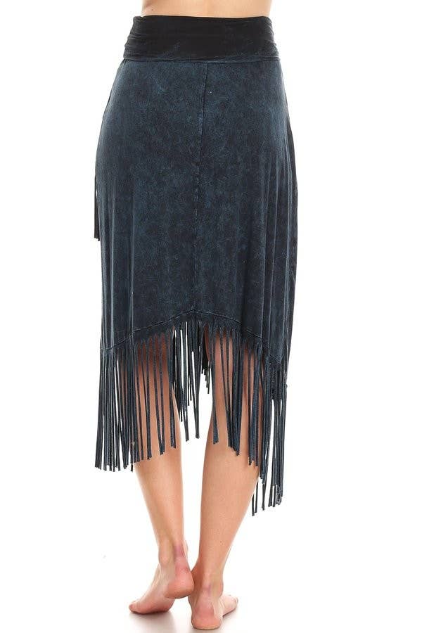 Black fringe skirt worn by a person on a white background