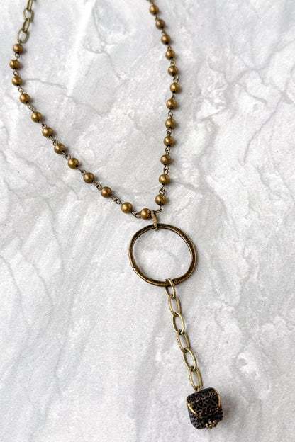 Necklace with a pendant on a textured white background