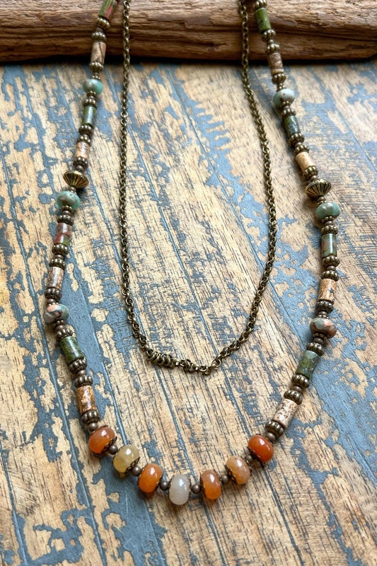 Beaded necklace with multicolored beads on a textured wooden surface