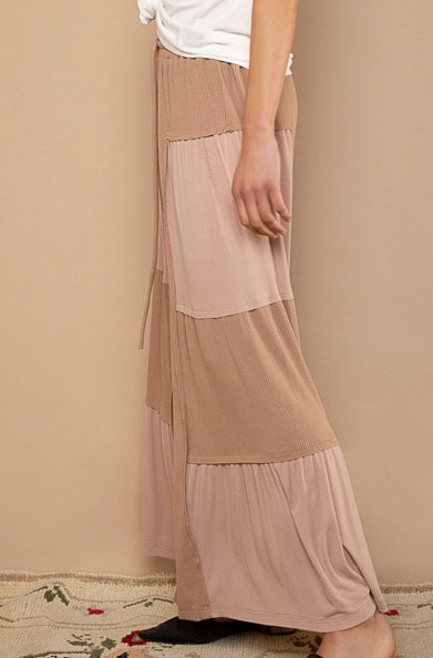 woman wearing chocolate colored patch  flowy pants-side view
