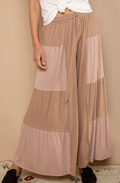 woman wearing chocolate colored patch  flowy pants