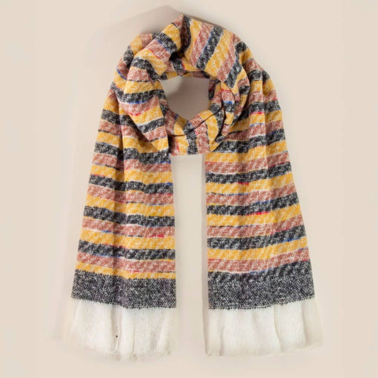Multicolored striped scarf with white tassels on a beige background