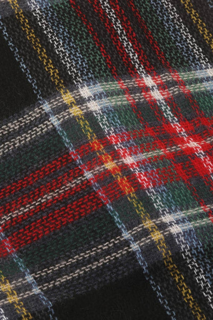 Close-up of plaid fabric with red, green, and yellow colors.