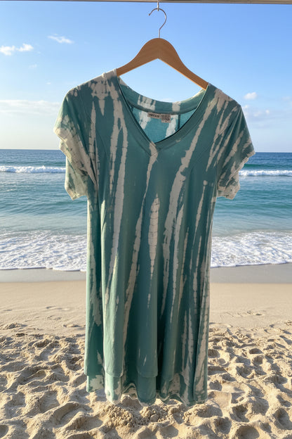 Teal and white tie-dye dress on a beach background