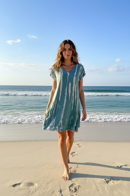 Woman wearing a Teal and white tie-dye dress on a beach background