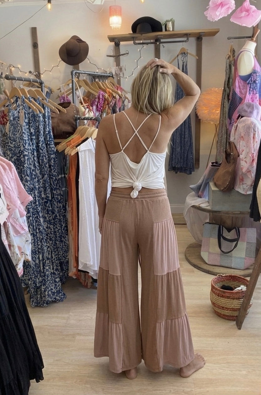 Back view of model Wearing chocolate colored flowy pants