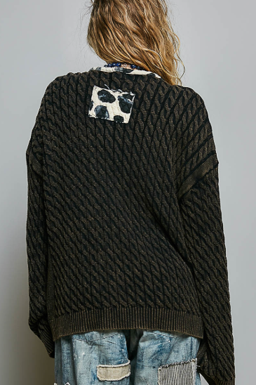 Open-Front Cable Knit Cardigan, Black with contrast ptch on back detIL ANd trim. The woman wearing it is walking out of Beach Gypsy in Berlin, MD.
