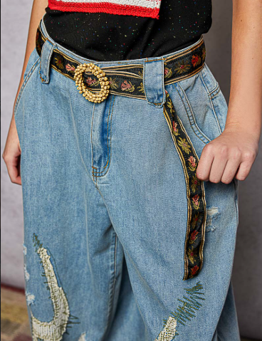 Black Embroidered Floral Fabric Belt side view paired with denim jeans and black top