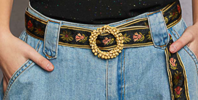 Black Embroidered Floral Fabric Belt with seed bead buckle-front view, paired with denim jeans and black shirt