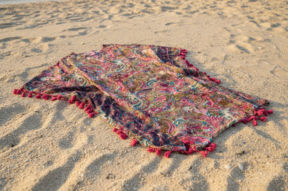 Back v with tassels on view of poncho coverup on sandy background