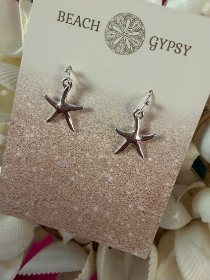 Starfish earrings on a 'Gypsy Beach' branded card with seashells in the background.
