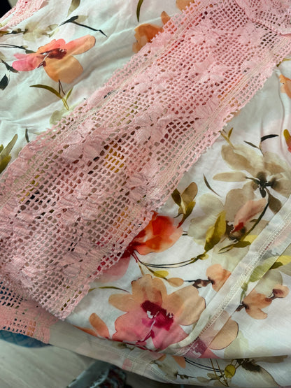 Pink lace fabric on a floral background