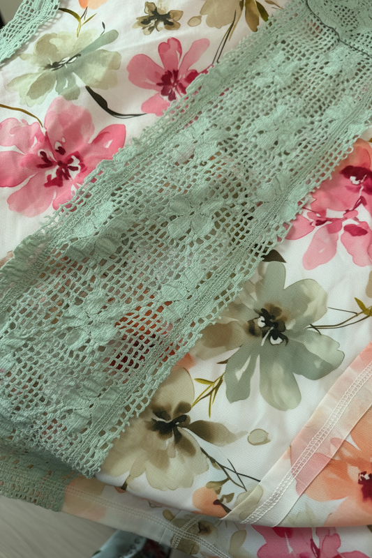 Close-up of green lace fabric on a floral background