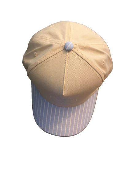 Top view of striped beach gypsy logo hat on a white surface
