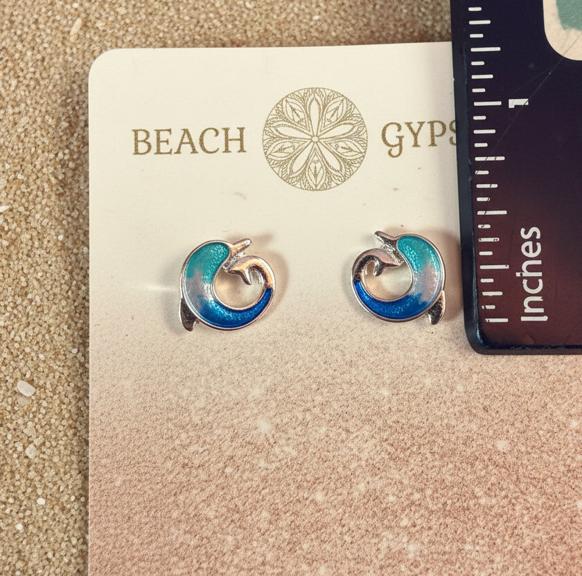 Small blue and silver dolphin earrings on Beach Gypsy branded with a ruler for scale.