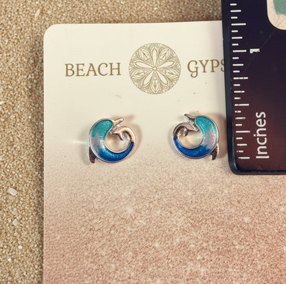 Small blue and silver dolphin earrings on Beach Gypsy branded with a ruler for scale.