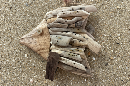 Handmade fish ornament on sandy beach background. Found in Berlin, MD near Ocean City Maryland. 
