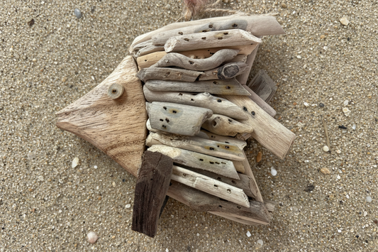 Handmade fish ornament on sandy beach background. Found in Berlin, MD near Ocean City Maryland. 