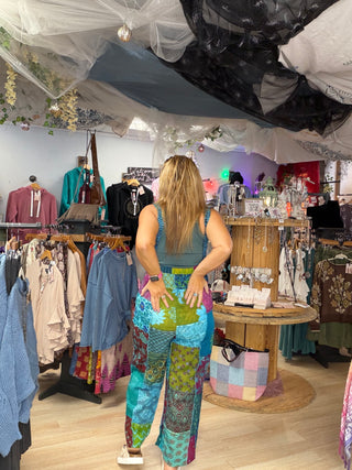 Back view of the patchwork jumpsuit showing the teal top and colorful wide-leg patchwork pants at Beach Gypsy