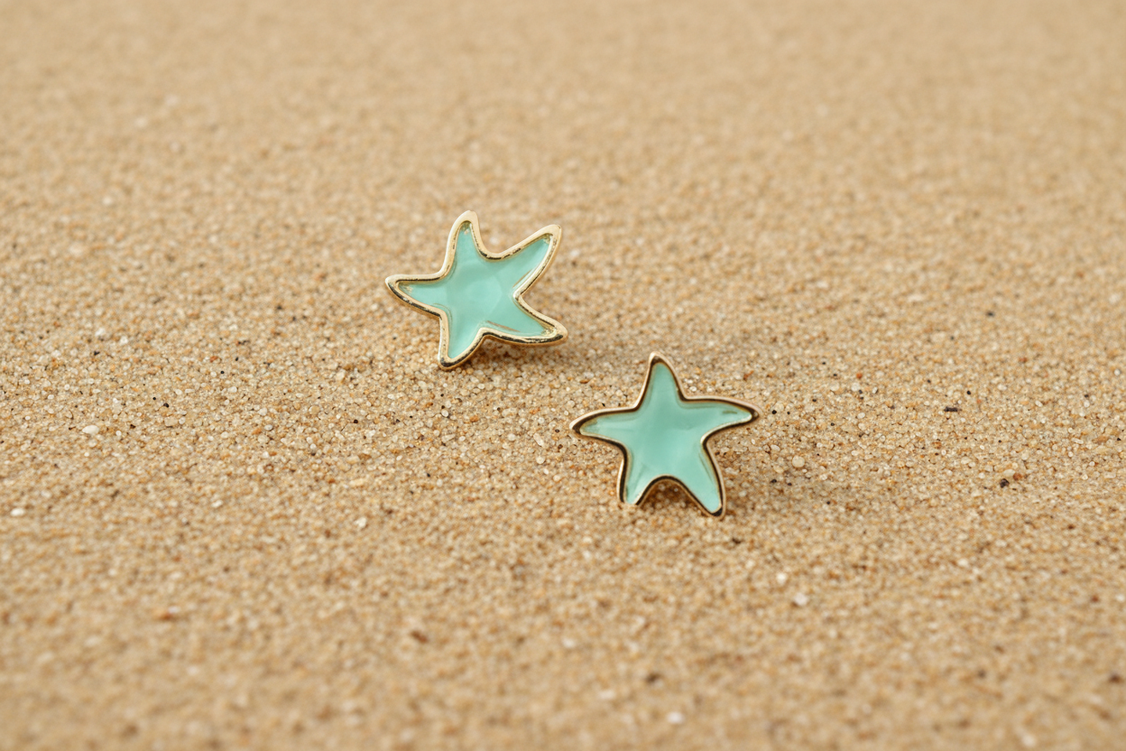 Starfish stud epoxy stud post earrings displayed on a sandy beach in Berlin, MD near Ocean City Maryland 