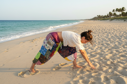 Woman doing yoga on beach wearing baggy patchwork harem pants 