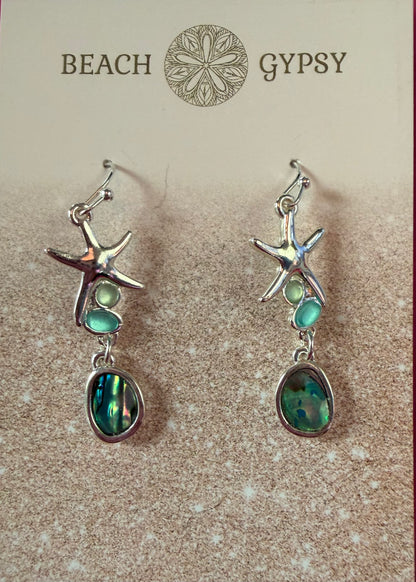 Starfish-shaped earrings with green stones on a 'Beach Gypsy' branded card.