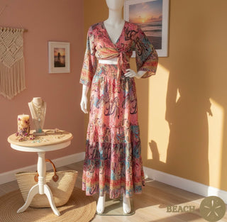 Mannequin wearing a patterned wrap top and flowy skirt in a room with decor elements.