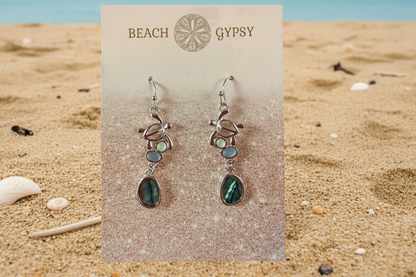 Turtles with abalone and sea glass on a beach