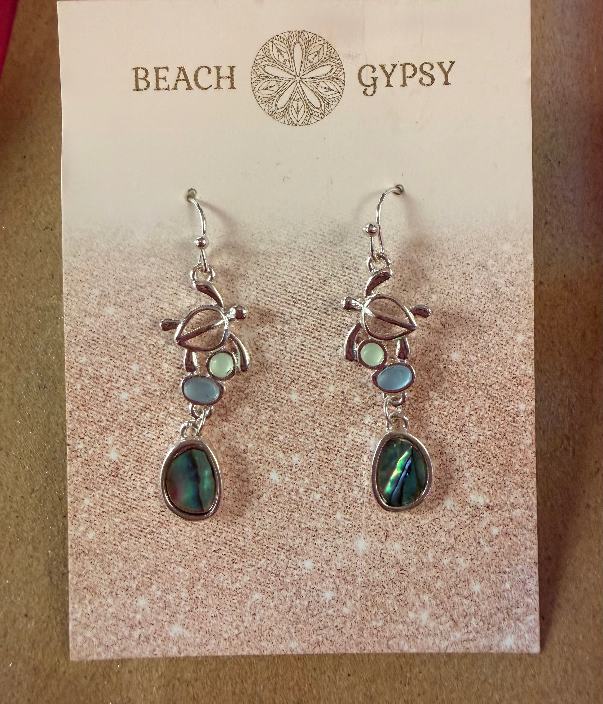 Pair of turtle earrings on a 'Beach Gypsy' branded card
