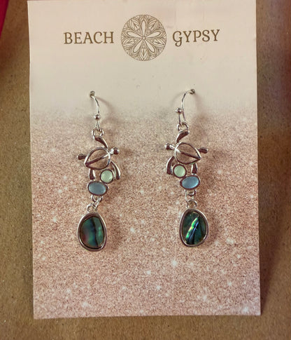 Pair of turtle earrings on a 'Beach Gypsy' branded card