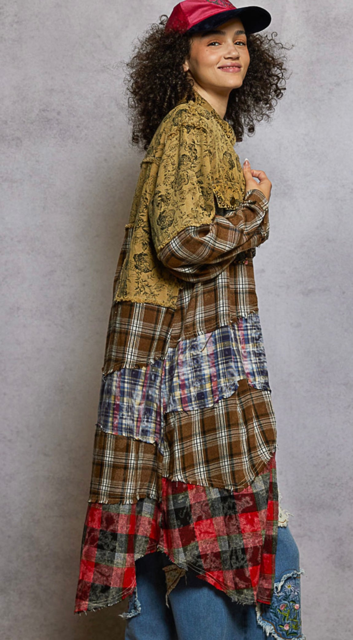 Person wearing a plaid dress with a textured background