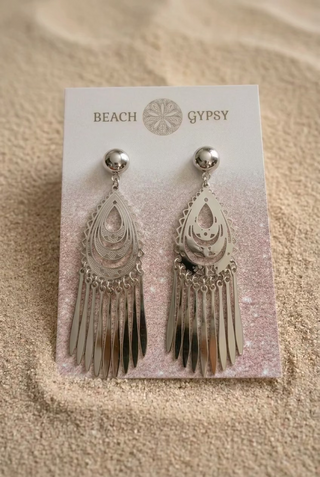 Silver Filigree Teardrop Fringe Earrings on a Beach Gypsy earring card, resting in beach sand