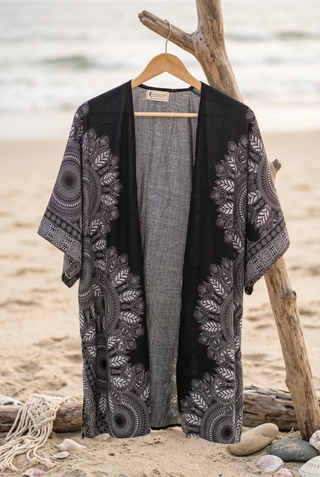 A black open-front kimono cardigan with intricate white mandala and floral patterns 